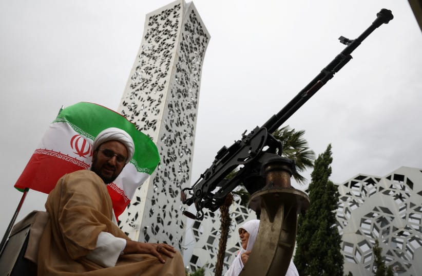 An Iranian couple arrive on a military vehicle during a public wedding ceremony called ''Sacrificed couple wedding'', in Tehran, Iran, May 18, 2026. (credit: MAJID ASGARIPOUR/WANA