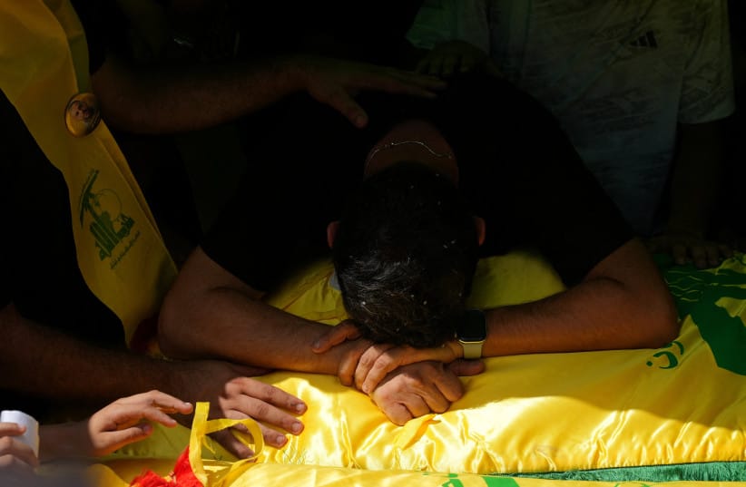 A mourner reacts as he attends the funeral of two Hezbollah fighters, who were killed before an interim deal between the U.S. and Iran, in Nabatieh, Lebanon, June 23, 2026.