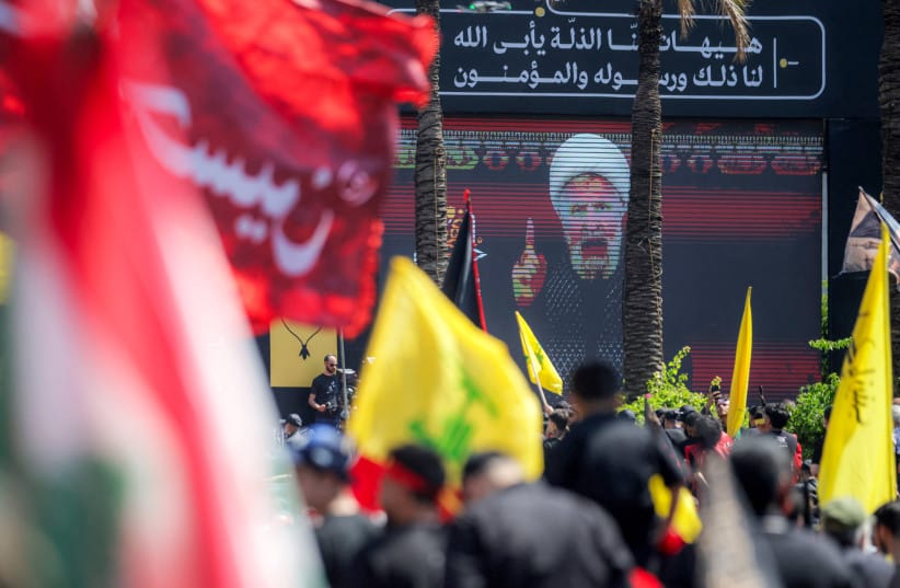 A crowd of Shia Muslim devotees watches as a televised speech by Naim Qassem, leader of Lebanese Shia movement Hezbollah, is displayed on a screen in Beirut, June 26, 2026. (credit: Ibrahim AMRO / AFP via Getty Images)