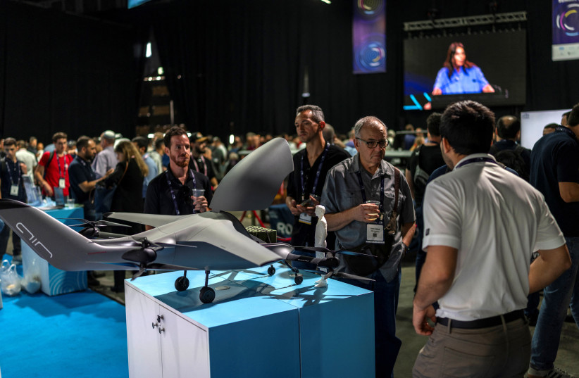 Visitors view a drone on display at the Smart Mobility Summit in Tel Aviv in 2026.