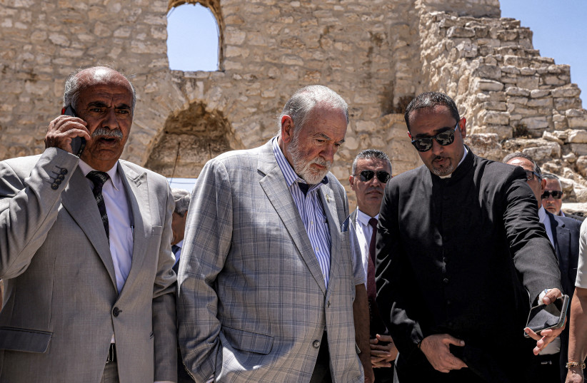 Huckabee (C) and the Palestinian mayor of the village of Taybeh, Suleiman Khourieh (L), tour the fifth-century Church of St George in the Palestinian Christian village of Taybeh, northeast of Ramallah in July 2025, days after an arson attack on the church.