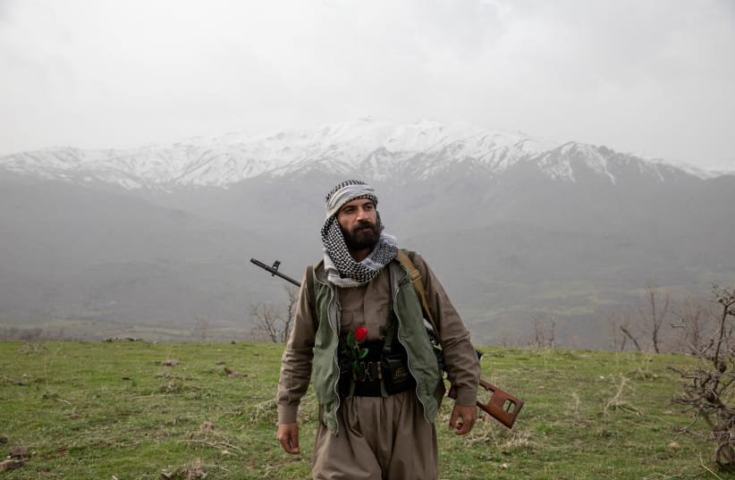 An armed Kurdish Peshmerga of the Komala party in a ceremony held in memory of Komala Martyrs' Day in Sidakan, Kurdistan Region of Iraq, on March 17, 2021.
