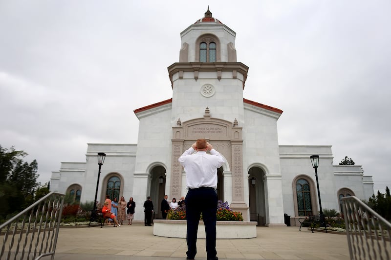 An attendee snaps a photo of the Yorba Linda California Temple of The Church of Jesus Christ of Latter-day Saints during its dedication in Yorba Linda, California, on Sunday, June 7, 2026.