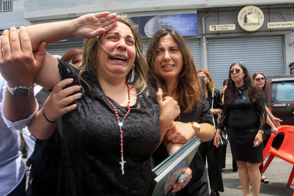 Rosette Tannous, wife of Lebanese army captain Elie Khoury, who was killed by Israeli bombardment, salutes as mourners carry her husband’s coffin in his home village in southern Lebanon on Monday. Photo: AFP