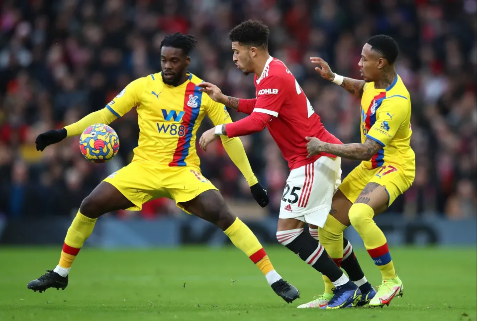 Jadon Sancho of Manchester United in action with Jeffrey Schlupp and Nathaniel Clyne of Crystal Palace during the Premier League match between Manchester United and Crystal Palace
