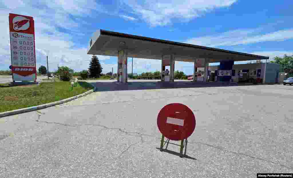 A closed gas station in Yevpatoriya, Crimea, on June 11.<br><br>In Russian-held Crimea, fuel supplies have virtually run dry amid a Ukrainian "middle strike" campaign that has targeted fuel tankers and other logistics hardware on the peninsula.