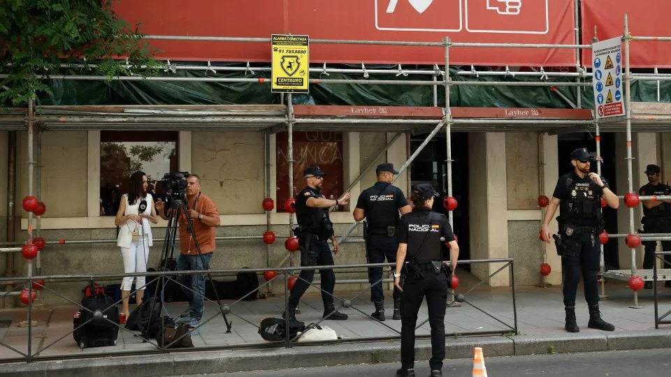 Police officers stand guard outside the ruling Spanish Socialist Workers’ Party (PSOE) headquarters after agents entered to demand documents on May 27, 2026. - Oscar del Pozo/AFP/Getty Images