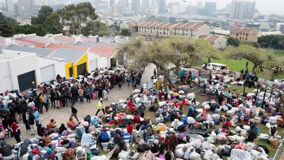 Hundreds of Zimbabwean migrants gather with their belongings outside the Zimbabwean Consulate in Cape Town on June 27, as they seek to be repatriated to Zimbabwe. - Rodger Bosch/AFP/Getty Images