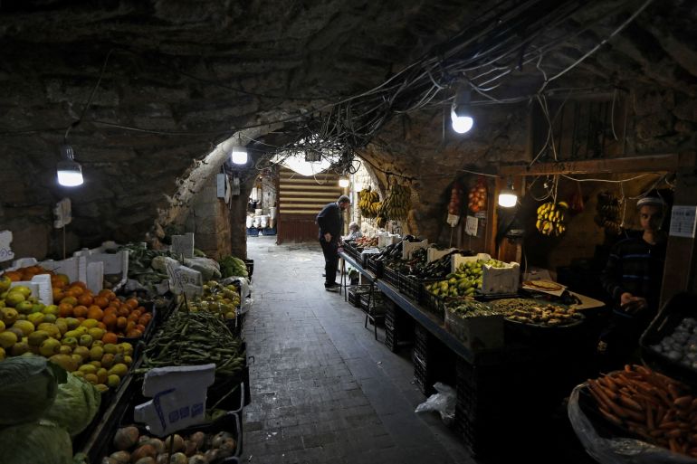 A man buys fresh produce in the market of the historic part of the southern coastal city of Sidon, on April 6, 2020. [Joseph Eid/AFP]