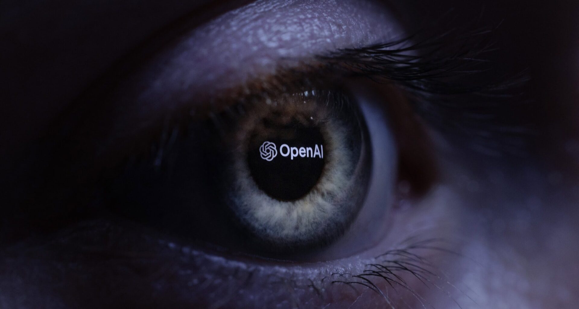 This illustration photograph taken with a macro lens shows an 'OpenAI' logo reverse projected onto a human eye at a studio in Paris on June 6, 2023. (JOEL SAGET / AFP)
