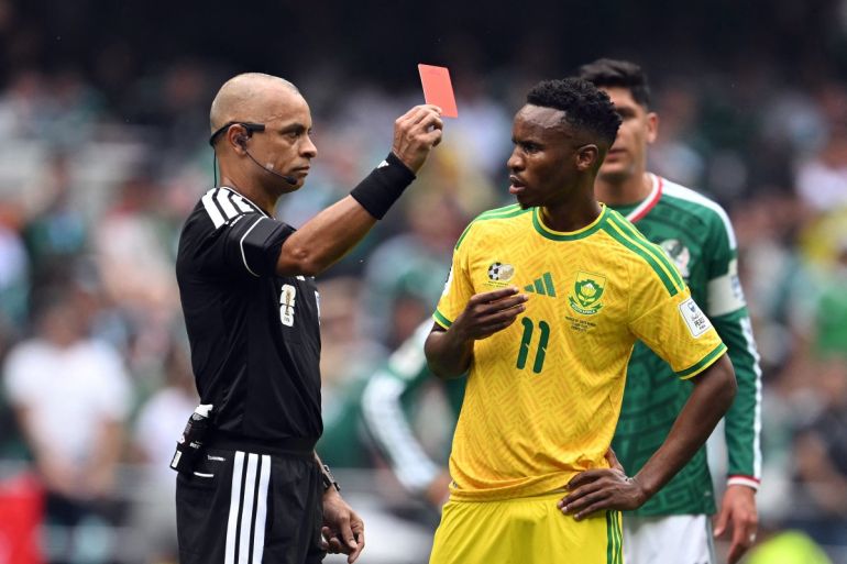 Brazilian referee Wilton Sampaio shows a red card to South Africa's midfielder #11 Themba Zwane during the 2026 World Cup Group A football match between Mexico and South Africa