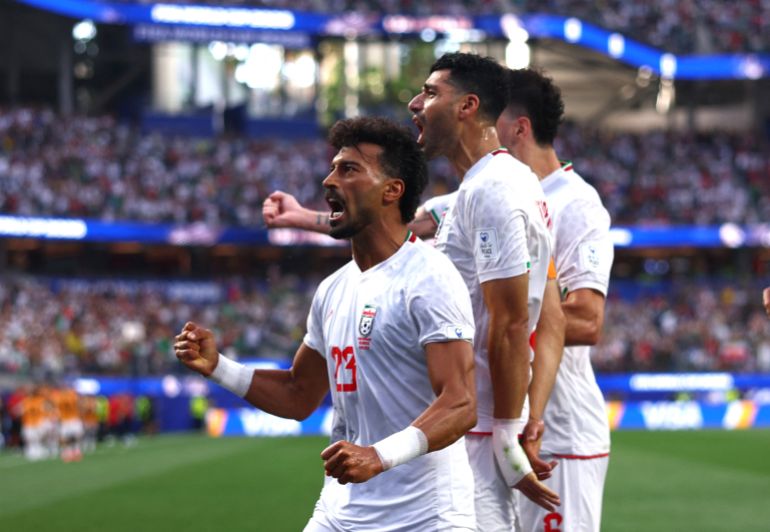 LOS ANGELES, CALIFORNIA - JUNE 15: Ramin Rezaeian #23 of IR Iran celebrates with teammates after scoring his team's first goal during the FIFA World Cup 2026 Group G match between IR Iran and New Zealand at Los Angeles Stadium on June 15, 2026 in Los Angeles, California. Dean Mouhtaropoulos/Getty Images/AFP (Photo by Dean Mouhtaropoulos / GETTY IMAGES NORTH AMERICA / Getty Images via AFP)