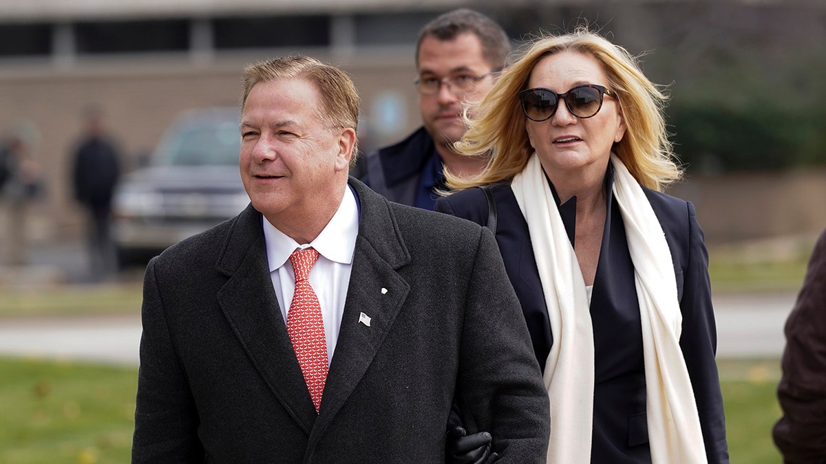 Mark McCloskey and Patricia McCloskey walking outside Kenosha County Courthouse