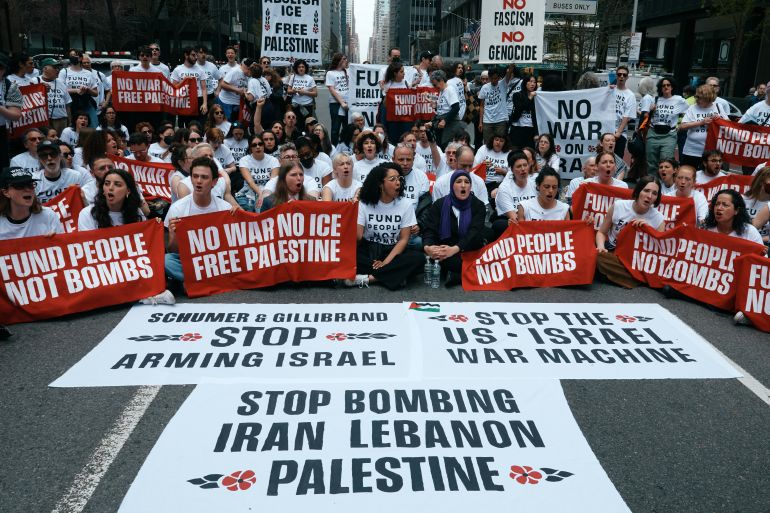 Protesters with Jewish Voice for Peace block traffic during a demonstration outside the New York office of U.S. Sen. Chuck Schumer, calling for an end to the U.S.-Israel war with Iran and opposing U.S. weapons support, Monday, April 13, 2026, in New York.