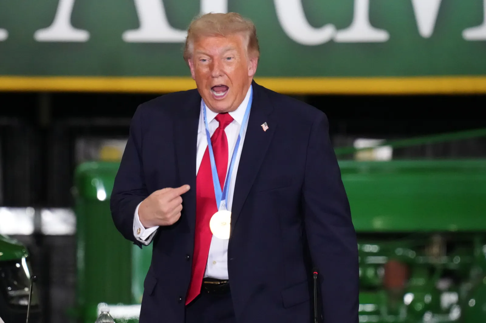 President Donald Trump wears a gold medal from Olympic speedskater Jordan Stolz at Custer Farms in Chippewa Falls, Wisconsin, on June 5. (AP Photo/Glen Stubbe)