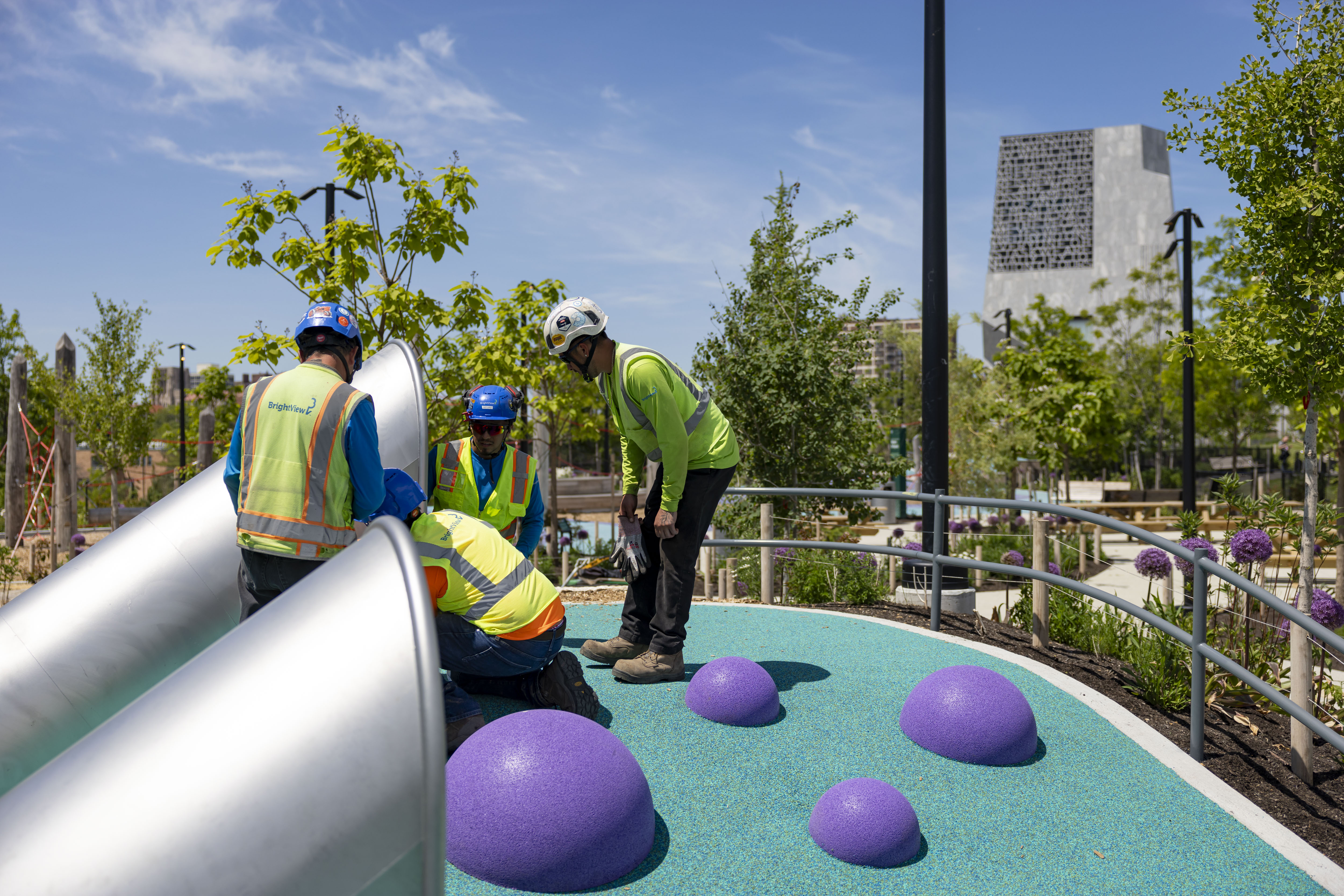 Workers prepare a slide on the playground as the Obama...