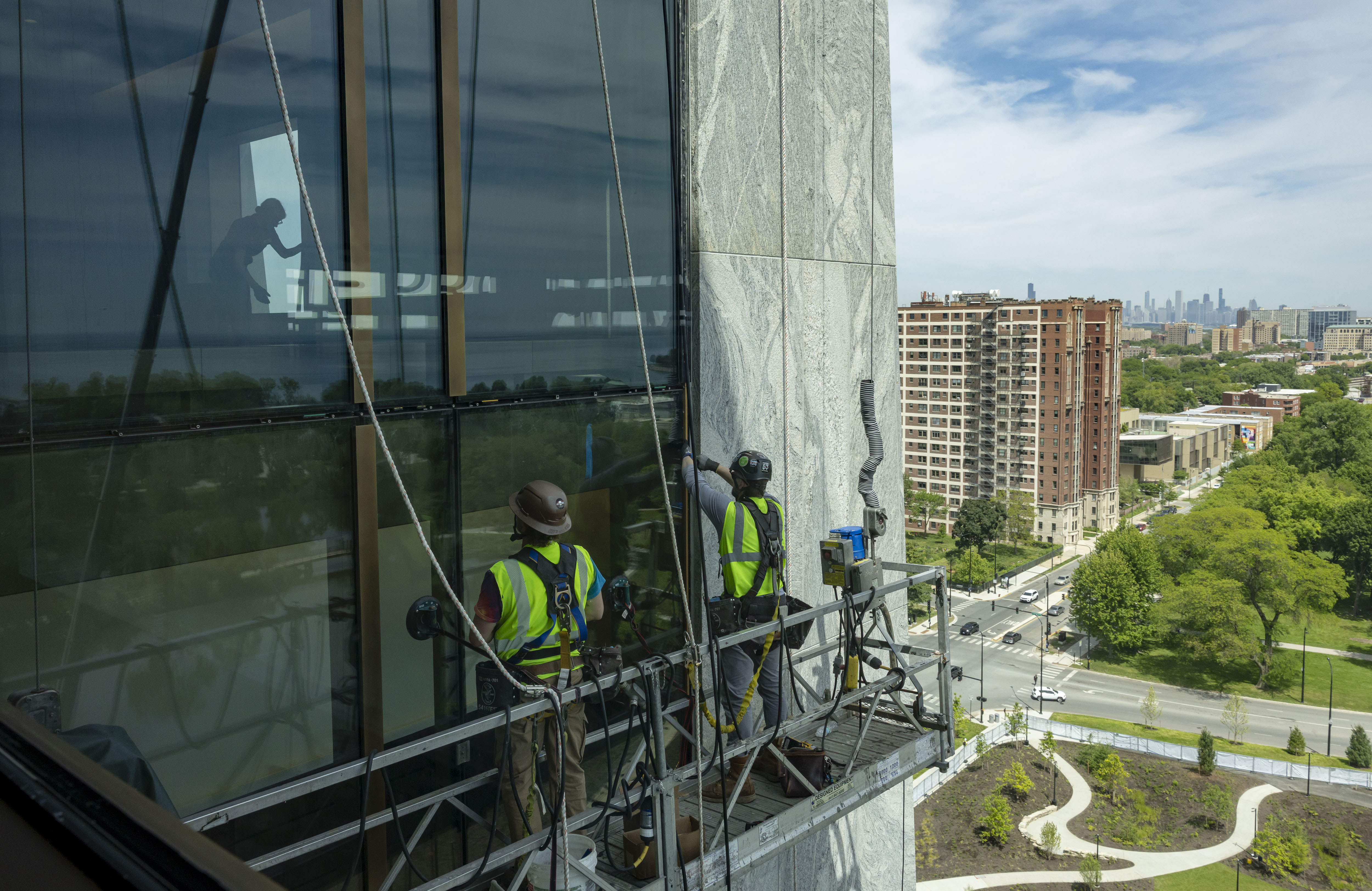 Workers replace a glass window panel as the Obama Presidential...