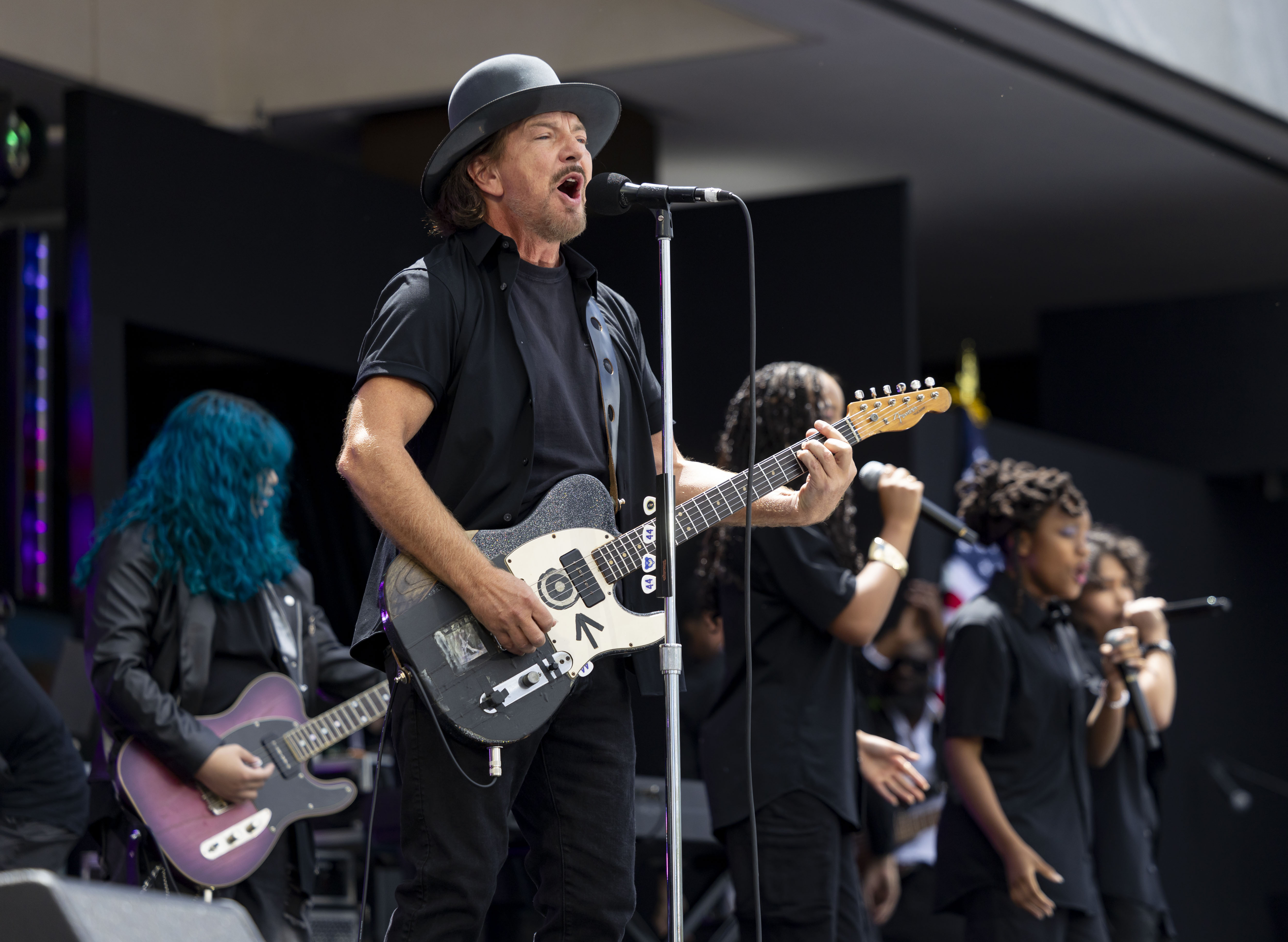 Eddie Vedder performs alongside students during the opening of the...