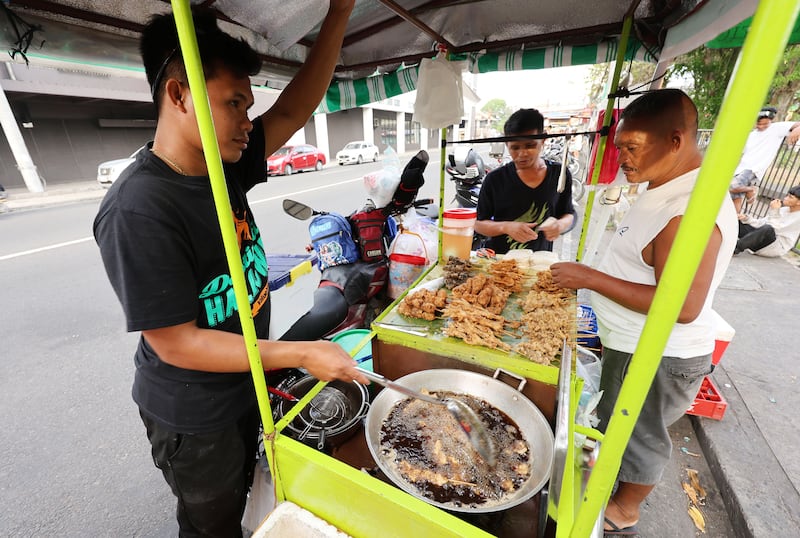 Food is cooked by a vendor in Bacolod City, Philippines, on Saturday, May 30, 2026.
