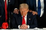 U.S. President Donald Trump prays during a roundtable discussion with Latino community leaders at Trump National Doral Miami resort in Miami, Florida, on October 22, 2024.