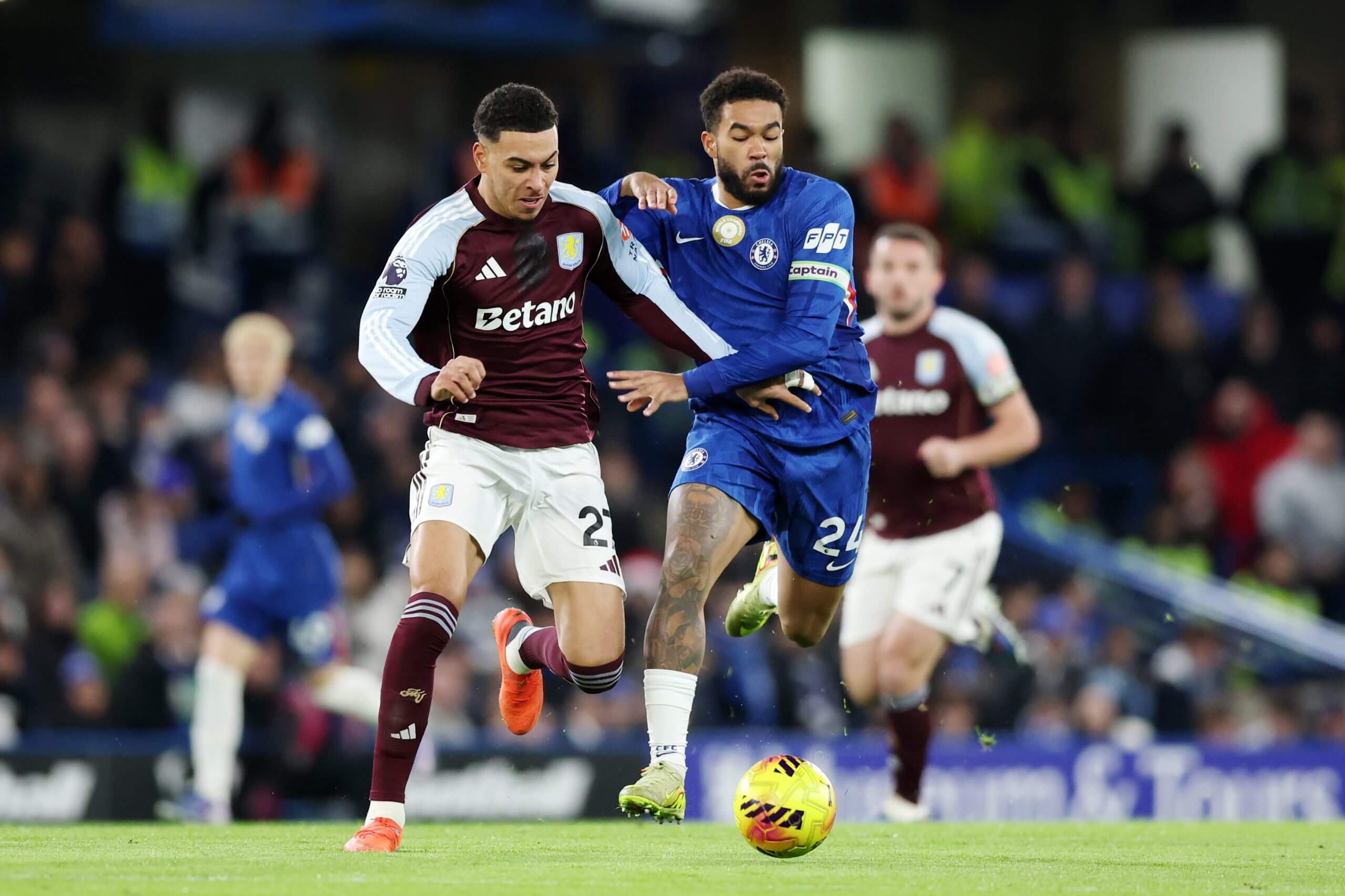 Morgan Rogers attempts to hold off Chelsea's Reece James