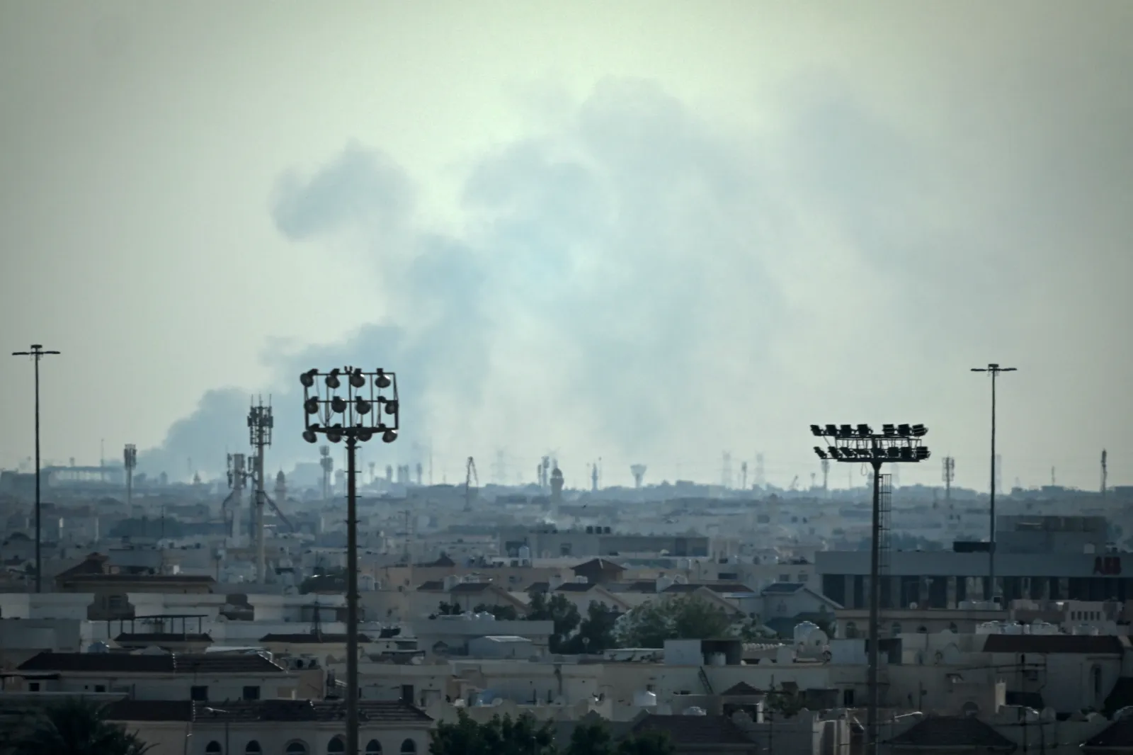 Smoke rises from an area in the direction of Al Udeid Air Base, on February 28, 2026, following a reported Iranian strike.