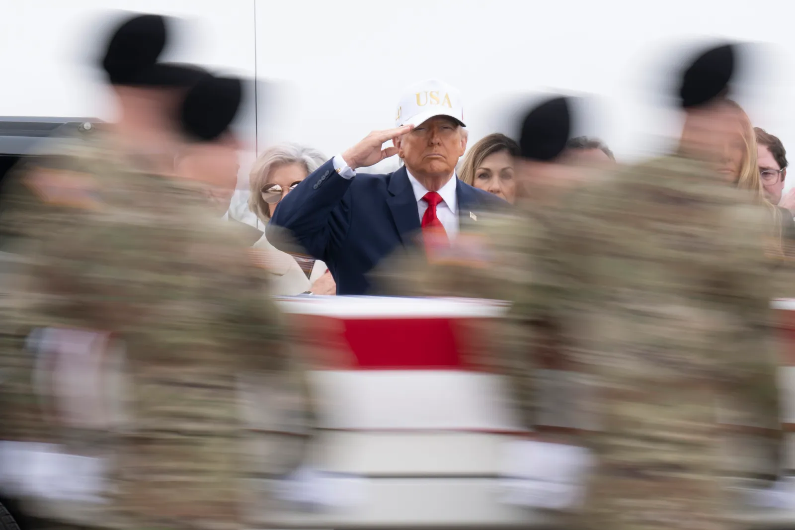 President Donald Trump salutes as soldiers transfer the remains of a sergeant killed in an Iranian drone strike in Kuwait, at Dover Air Force Base on March 7, 2026.