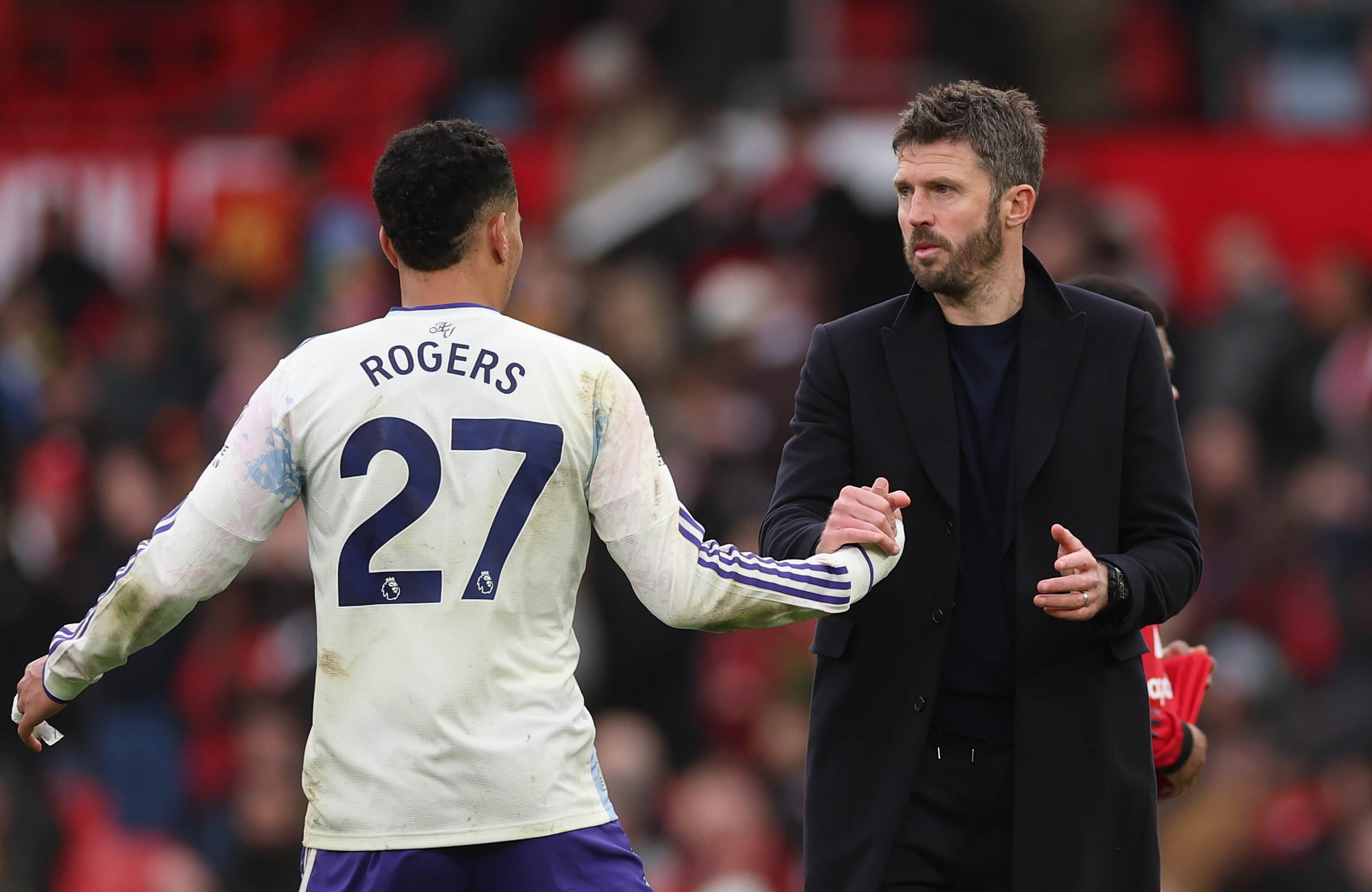 Morgan Rogers claps hands with Michael Carrick