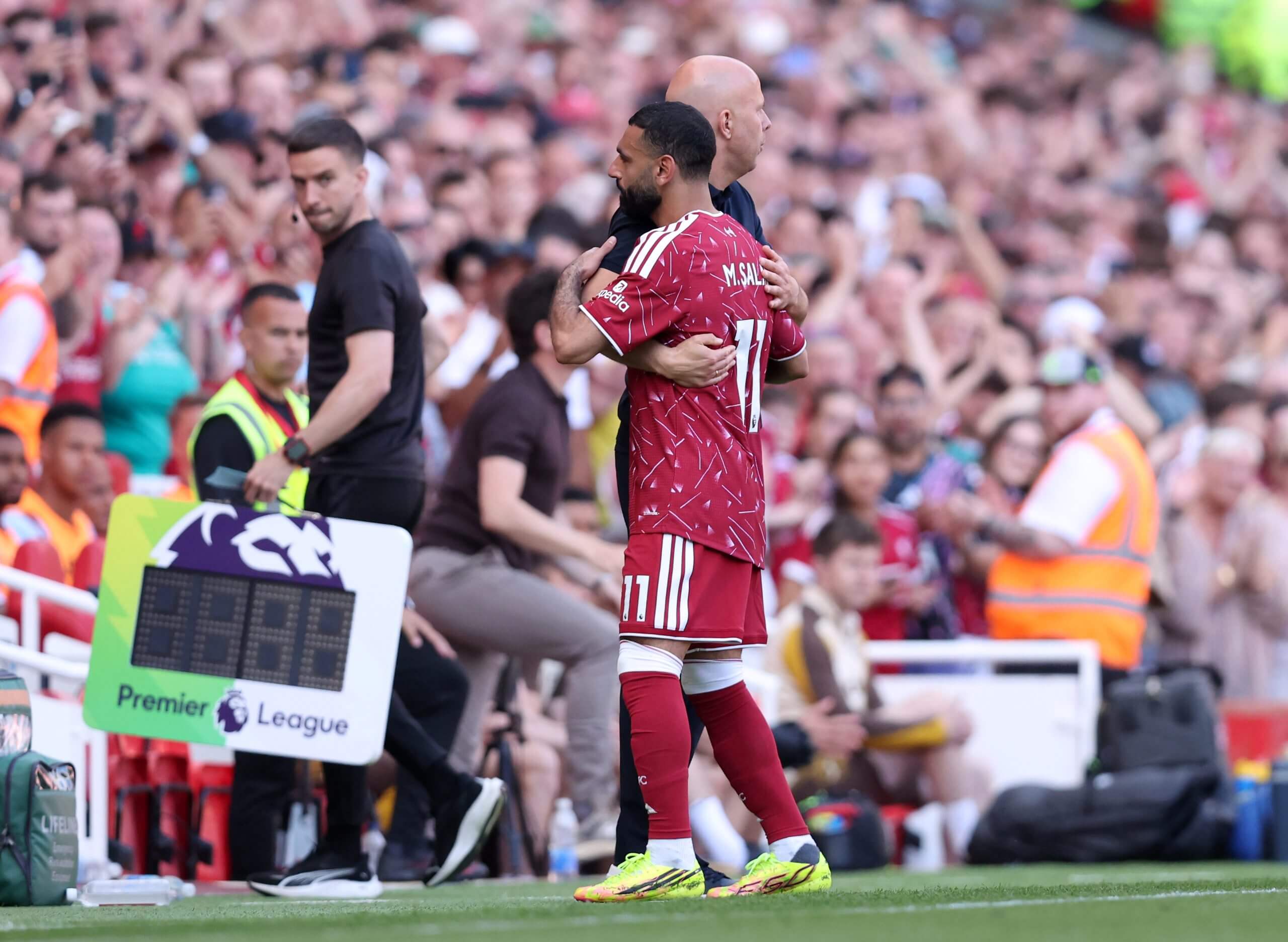 Arne Slot and Mohamed Salah embrace on the sideline