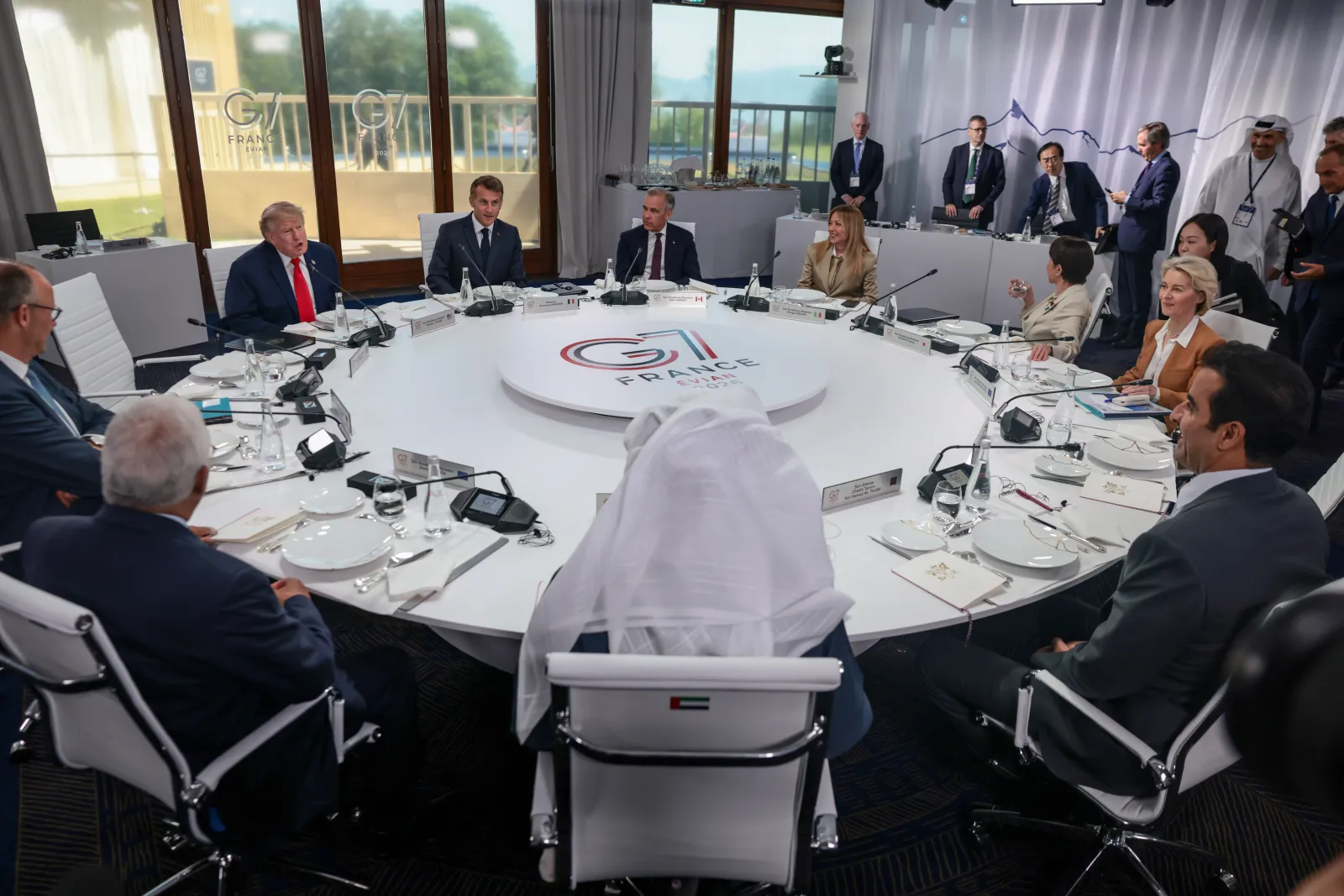 President Donald Trump, French President Emmanuel Macron, Canadian Prime Minister Mark Carney, Italian Prime Minister Giorgia Meloni, Japanese Prime Minister Sanae Takaichi, European Commission President Ursula von der Leyen, Qatar Emir Sheikh Tamim bin Hamad Al Thani, President of the United Arab Emirates (UAE) Sheikh Mohamed bin Zayed Al Nahyan, European Council President Antonio Costa, and German Chancellor Friedrich Merz take part a working lunch with leaders of G7 and the Middle East, on June 16 in Evian-les-Bains, France. (Photo by Evelyn Hockstein - Pool/Getty Images)