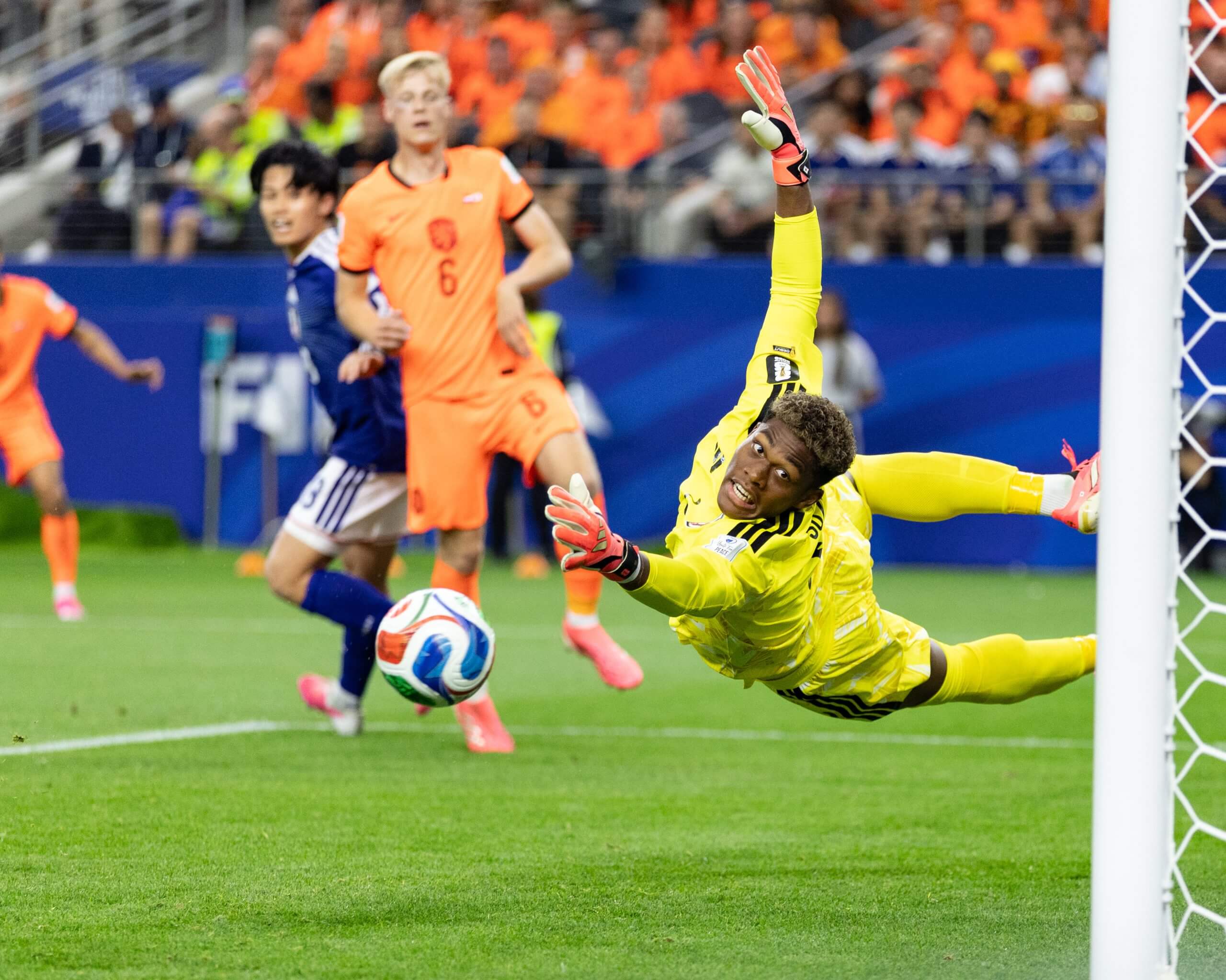 An airborne Zion Suzuki watches as Virgil van Dijk's header find the net
