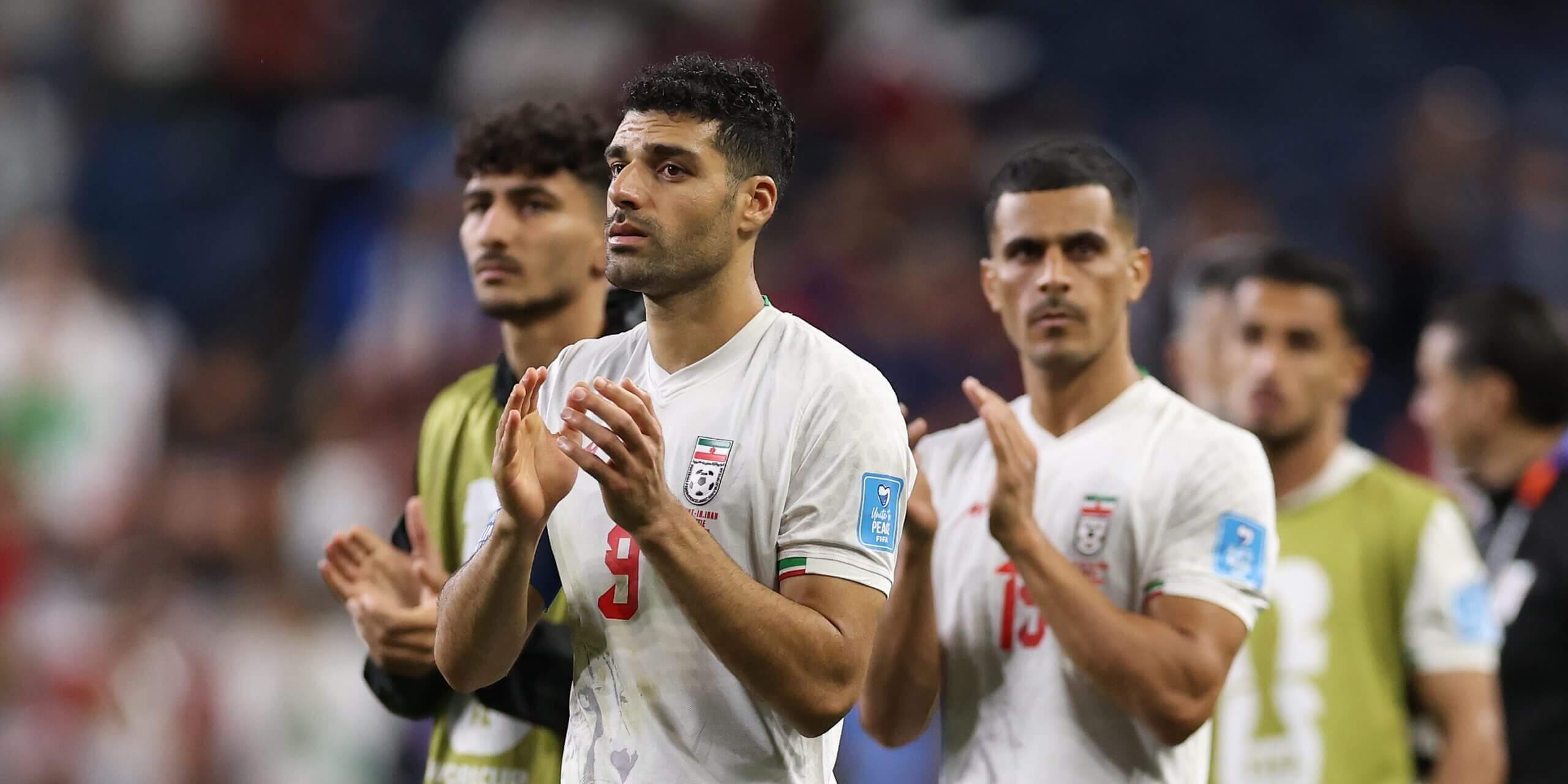 Mehdi Taremi claps alongside other Iranian players