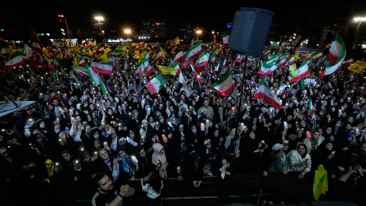 Demonstrators wave Iranian flags and flags of Lebanon's militant Hezbollah group during a pro-government gathering at Islamic Revolution Square in Tehran, Iran, Saturday, May 30, 2026. (AP Photo/Vahid Salemi)