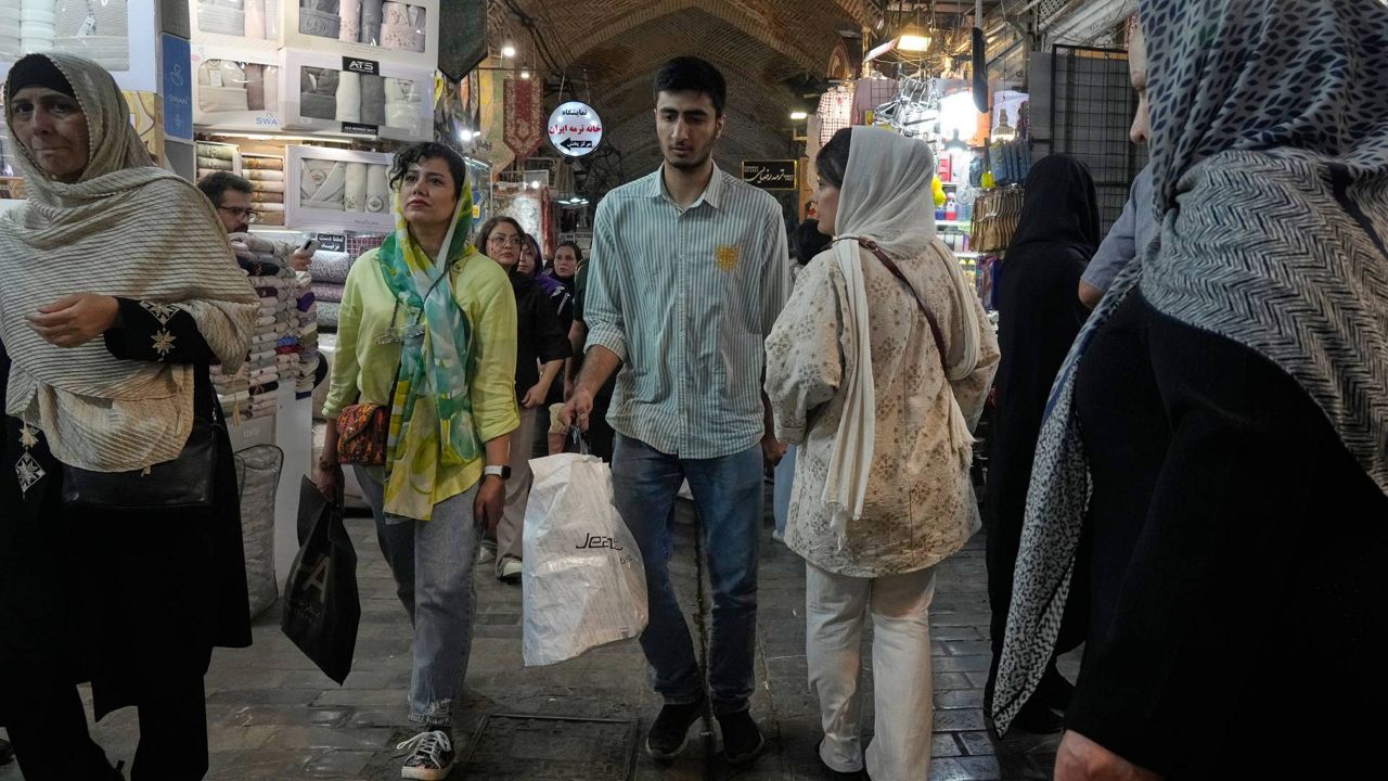 People walk at Tehran's historic Grand Bazaar, Iran, Monday, June 1, 2026. (AP Photo/Vahid Salemi)