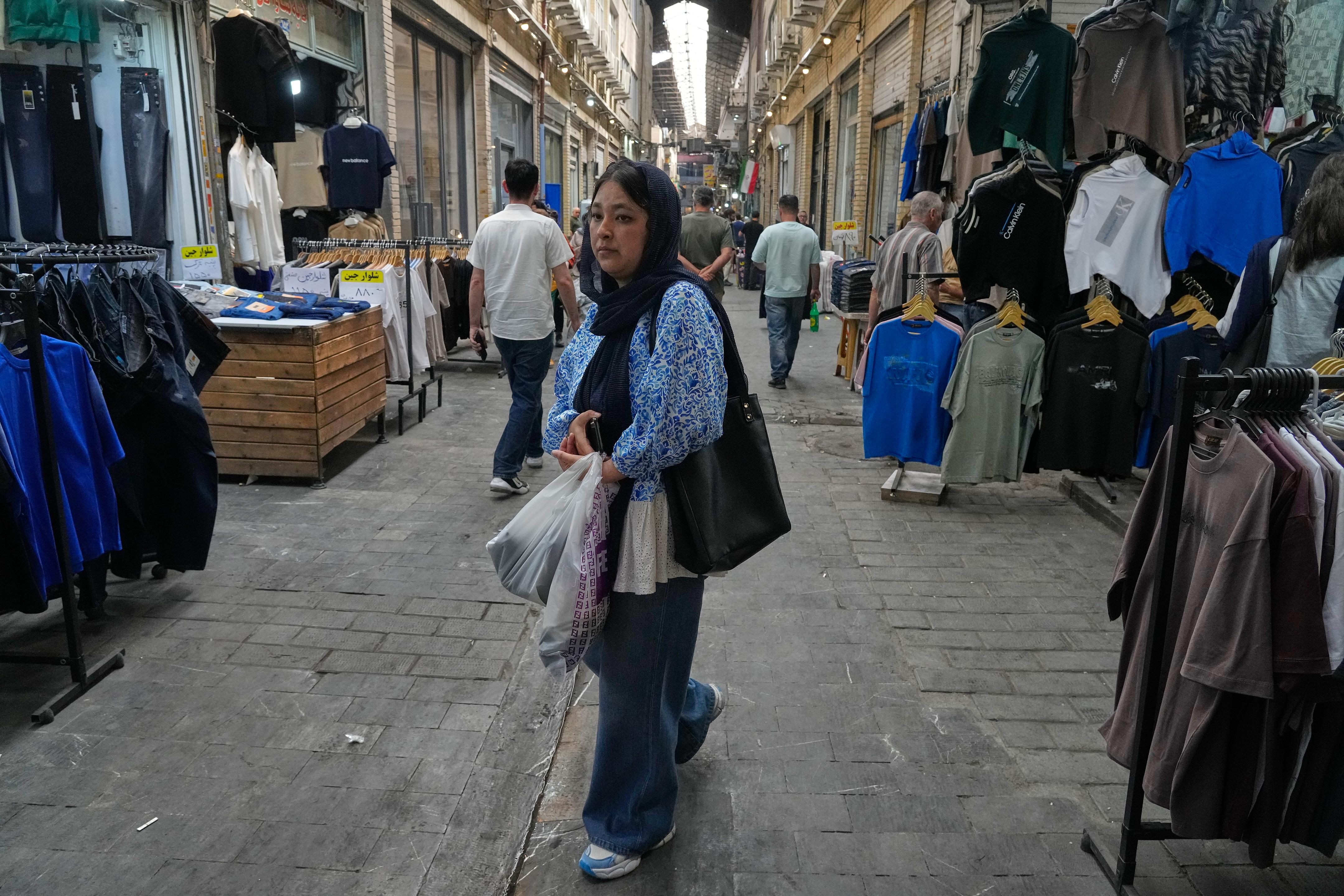 A woman walks at Tehran's historic Grand Bazaar, Iran.