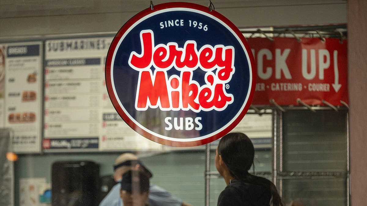 Customers standing inside Jersey Mike's store