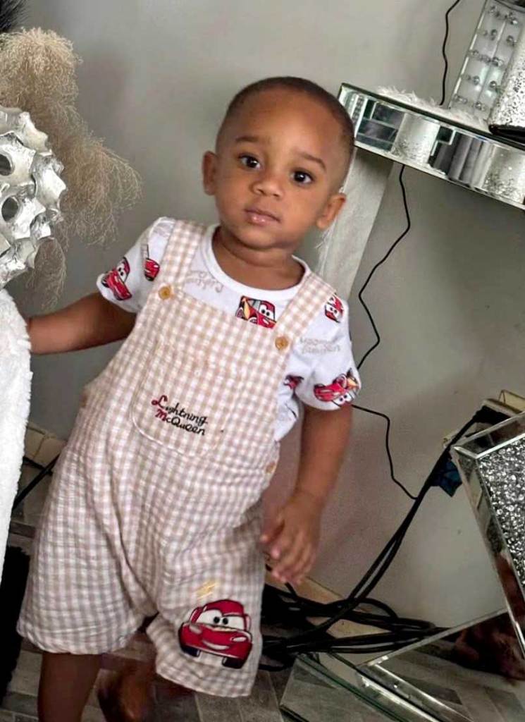 Kohen Wiley in a cars themed outfit stands in a living room