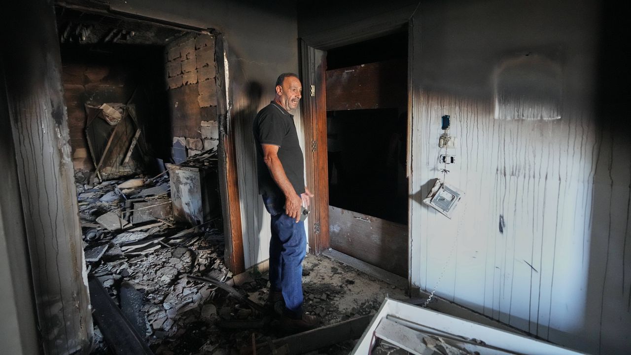 Resident Samih Haidar reacts as he inspects his burned apartment damaged in Israeli strikes in the southern port city of Tyre, Lebanon, Thursday, June 18, 2026. (AP Photo/Hassan Ammar)