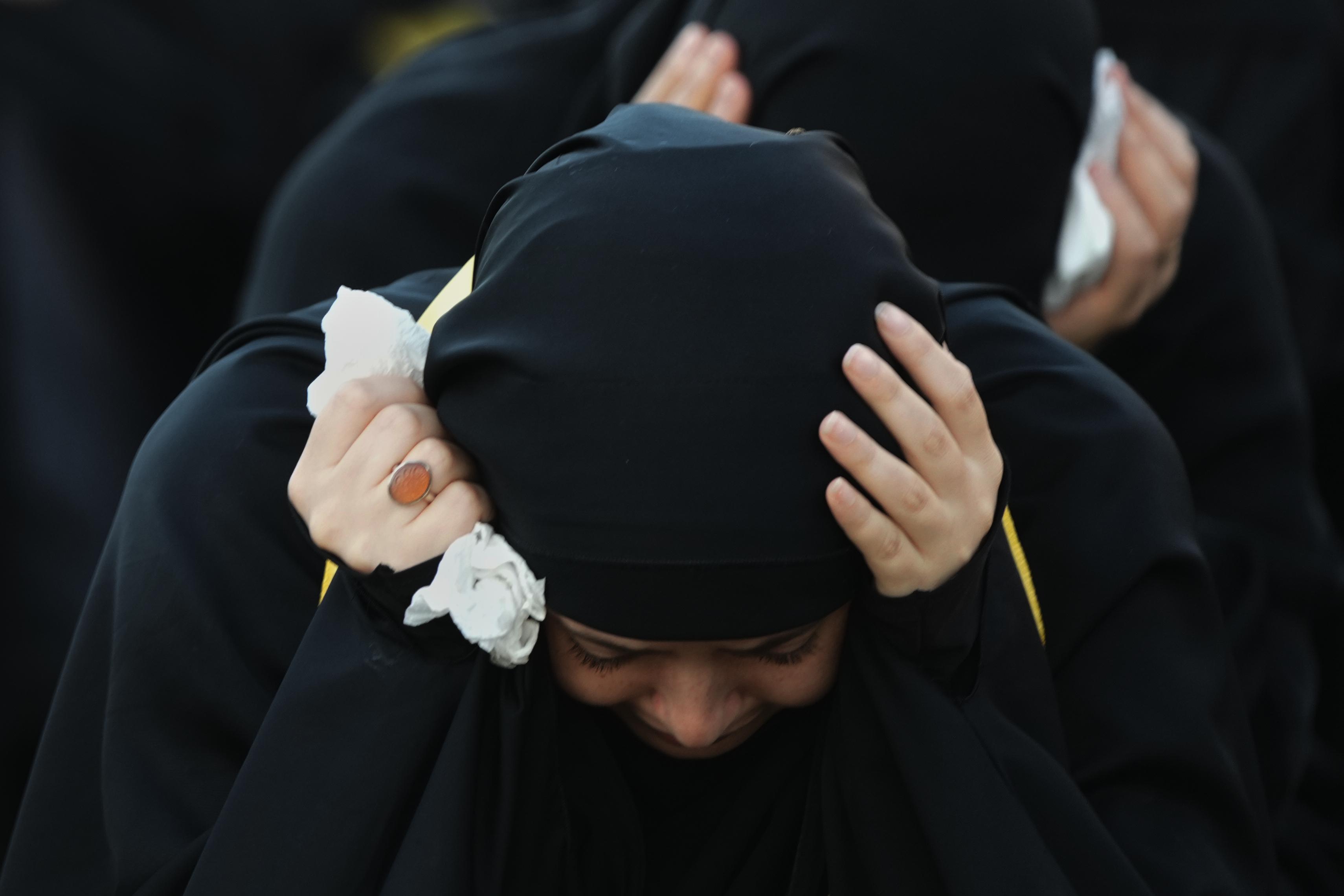 A woman mourns during a sermon marking the third day...