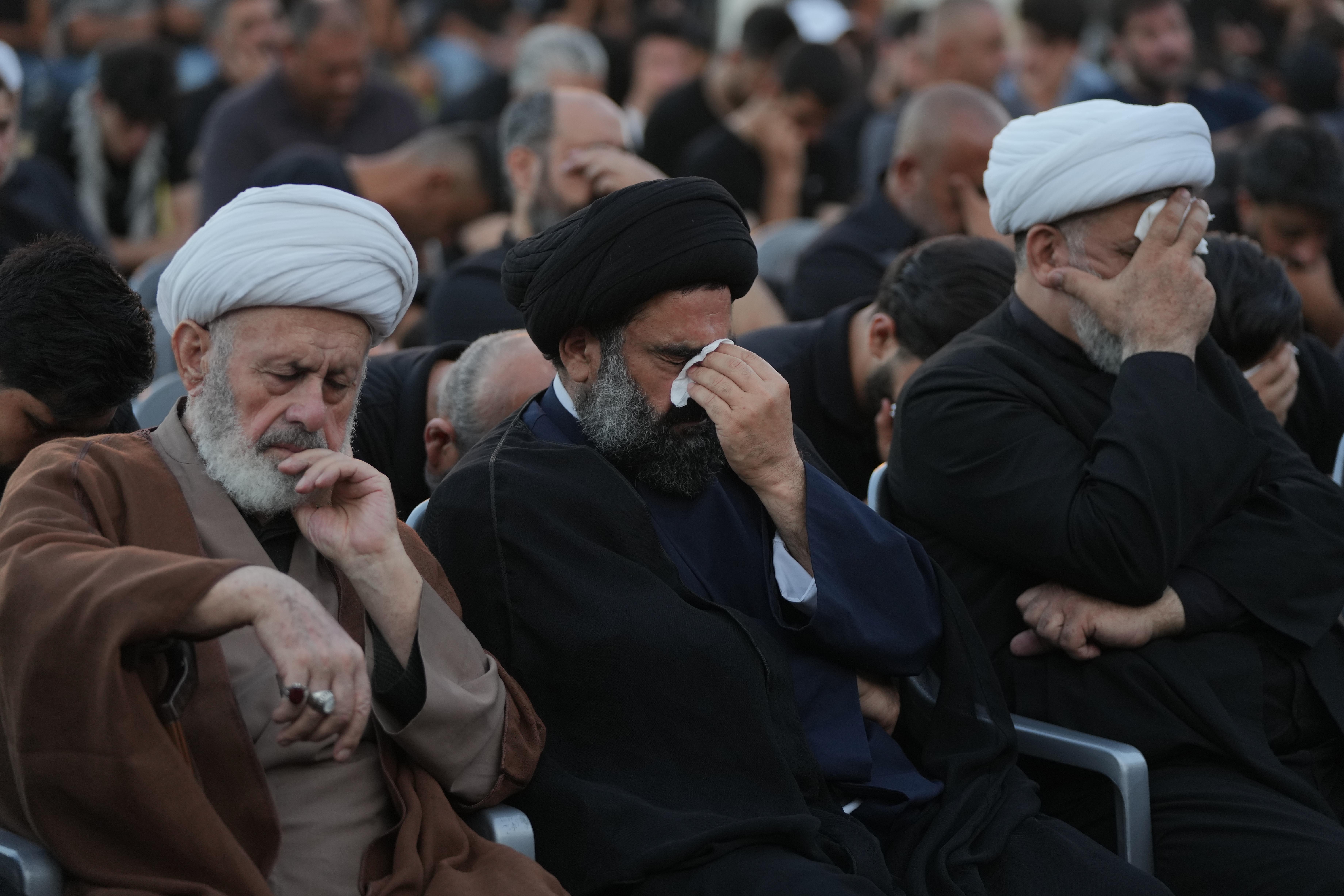 Shiite clerics and mourners weep during a sermon marking the...