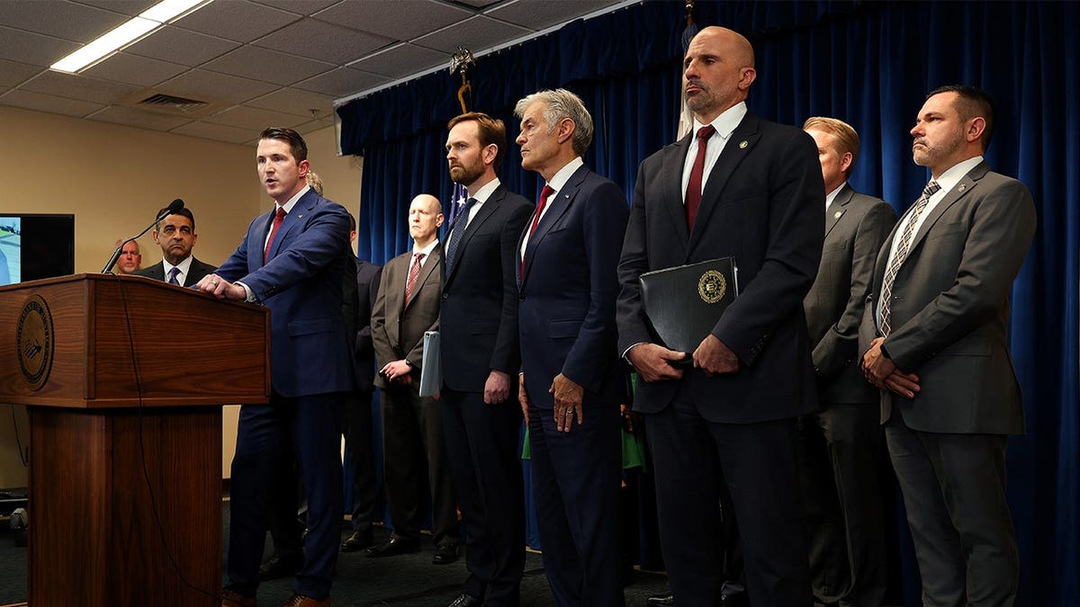 Government officials stand at a podium in Minnesota