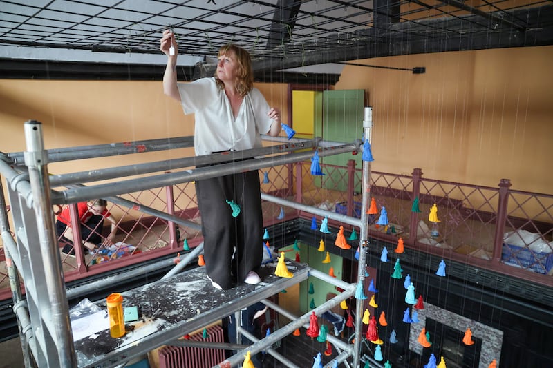 Rachel Carter in Shodfriars Hall hanging 3D-printed models as part of an artwork about the establishment of Boston, Massachusetts. Photograph: Enda O'Dowd
