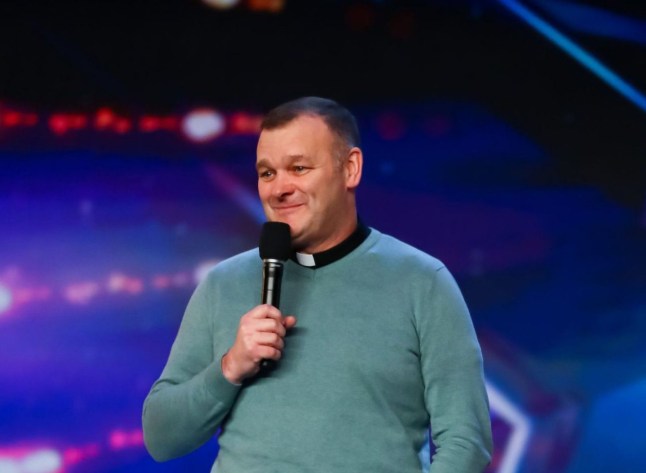 Allan Finnegan wears a green jumper with a dog's collar on BGT.