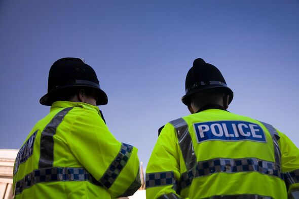 Two British Policemen wearing Traditional Helmets Two British Policemen wearing Traditional Helmets