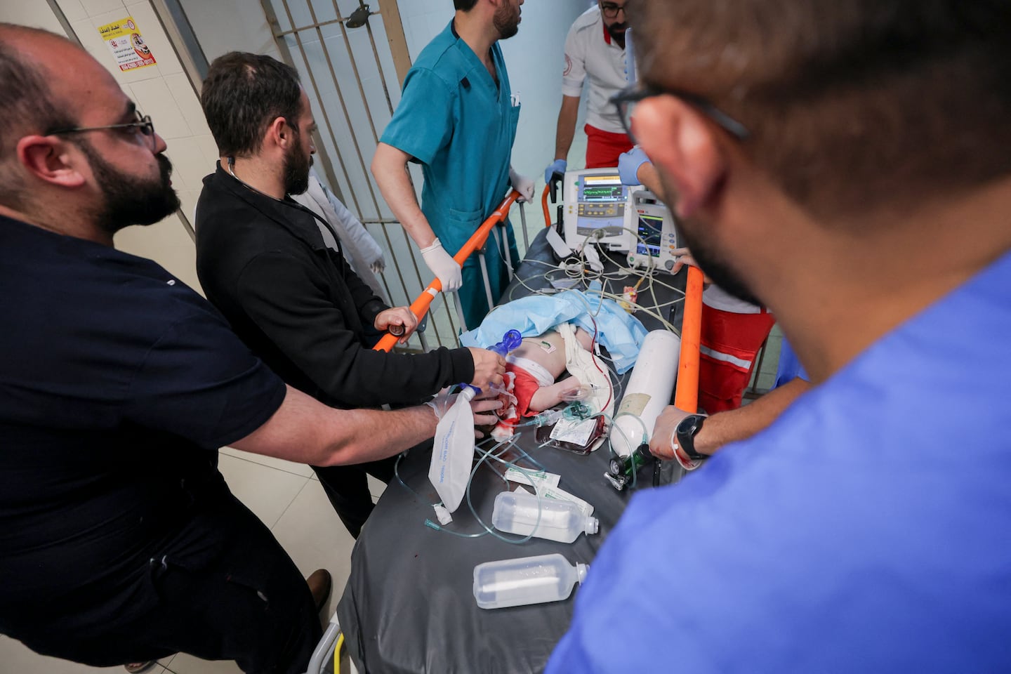 Palestinian medical workers surround a wounded baby on a stretcher at a hospital in Hebron in the occupied West Bank, on June 5, 2026. A seven-month-old baby was critically wounded and his parents were injured during an Israeli military operation in the Wadi al-Hariya area.