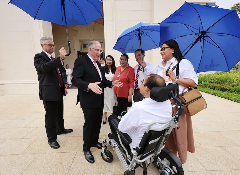Elder Neil L. Andersen of the Quorum of the Twelve Apostles greets members of the Villanueva family before the Bacolod Philippines Temple dedication in Bacolod City, Philippines, on Sunday, May 31, 2026.