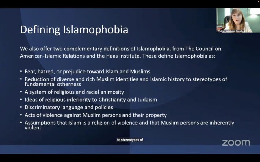 Screenshot from a Zoom presentation titled “Defining Islamophobia.” A slide lists complementary definitions from the Council on American-Islamic Relations and the Haas Institute, describing Islamophobia as fear, hatred or prejudice toward Islam and Muslims; reducing diverse Muslim identities to stereotypes; religious and racial animosity; beliefs that Islam is inferior to Christianity and Judaism; discriminatory language and policies; violence against Muslims and their property; and assumptions that Islam and Muslims are inherently violent. A small video window in the upper-right corner shows presenter Whitney Wilkinson Arreche speaking.