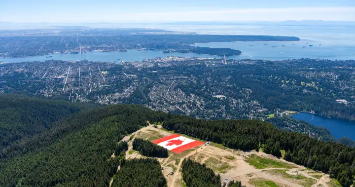 Grouse Mountain unveils giant Canadian flag as FIFA World Cup set to begin - BC