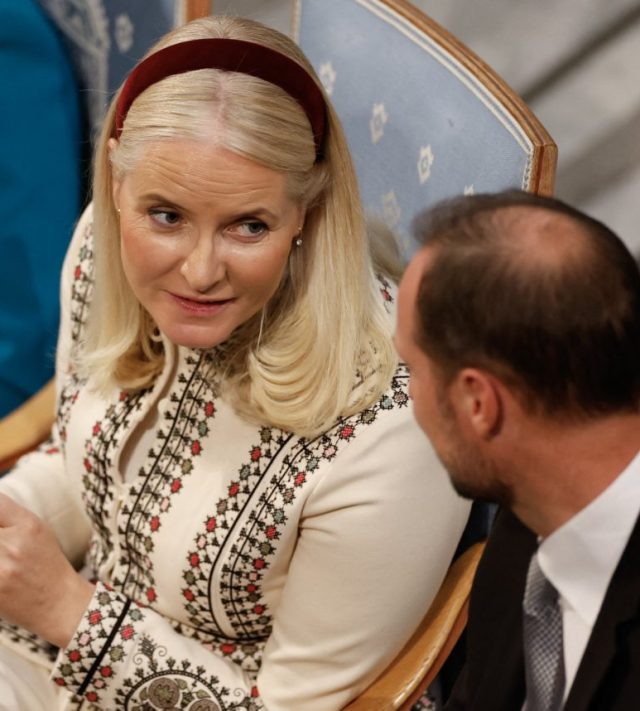 (FILES) Crown Princess Mette-Marit of Norway talks with Crown Prince Haakon of Norway (R) as they attend the Nobel Peace Prize award ceremony at the Oslo City Hall in Oslo, Norway on December 10, 2024. Norwegian Crown Princess Mette-Marit's life was once the stuff of fairytales, but rape charges against her son and her recently revealed friendship with convicted US sex offender Jeffrey Epstein have seen it rapidly turn into a nightmare. The tale of the single mother from humble beginnings, whose chance encounter with Crown Prince Haakon propelled her to the heart of the monarchy, won the affection of Norwegians. But her frequent exchanges with Epstein, published this weekend in Norwegian media, have exposed an unsuspected relationship that has shocked the Scandinavian country. (Photo by Odd ANDERSEN / AFP via Getty Images)