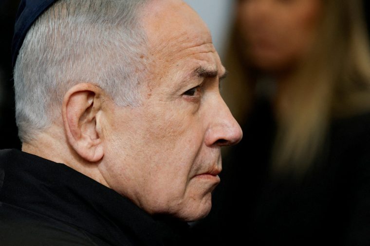 FILE PHOTO: Israeli Prime Minister Benjamin Netanyahu attends a memorial service held for Ran Gvili, an off-duty police officer who was killed fighting militants that had infiltrated Israel during the deadly October 7, 2023, attack by Hamas, and the last hostage recovered from Gaza, in Meitar, Israel, January 28, 2026. REUTERS/Amir Cohen TPX IMAGES OF THE DAY/File Photo